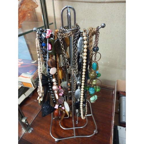 360 - A quantity of costume jewellery necklaces on stand