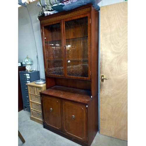 448 - A mahogany dresser with inlaid panelled cornice and deep cut glazed doors