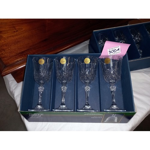 300A - A boxed set of 6 Bohemia cut glass wine glasses and a boxed set of 4 Cristal D'Arques cut glass wine... 