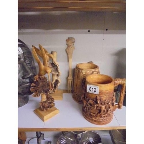 612 - Two carved wood birds, Two Scottish themed tankards and a wooden fork.