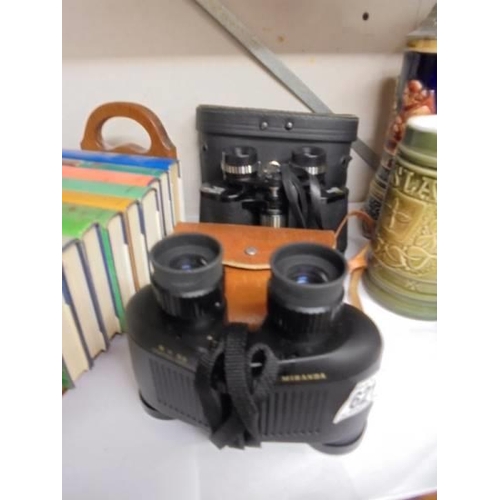 621 - Two cased pairs of binoculars.