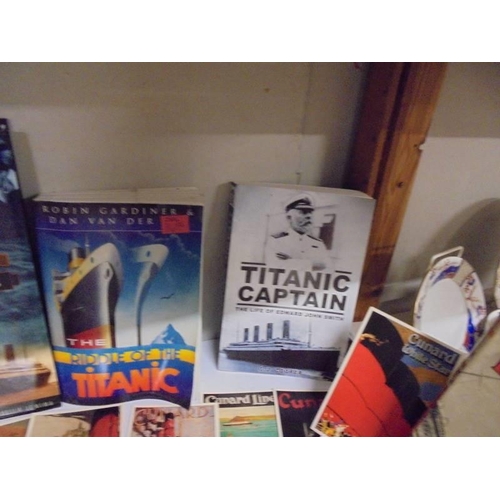 623 - A collection of Titanic related books and Cunard Line postcards.