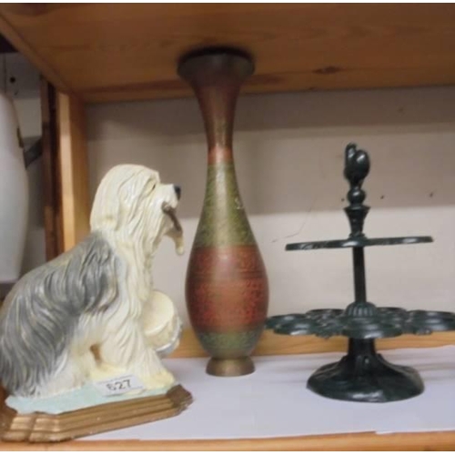 627 - A cast iron old English sheep dog door stop, a cast iron egg stand and a metal vase.