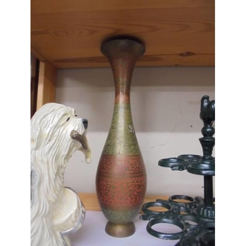 627 - A cast iron old English sheep dog door stop, a cast iron egg stand and a metal vase.