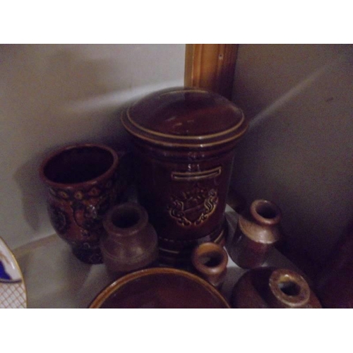 631 - A mixed lot of stoneware bottles, lidded dishes etc.,