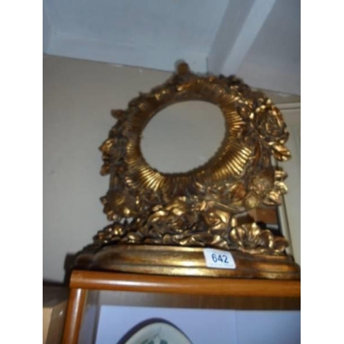 642 - An ornate gilded circular mirror frame. (no glass).  COLLECT ONLY.