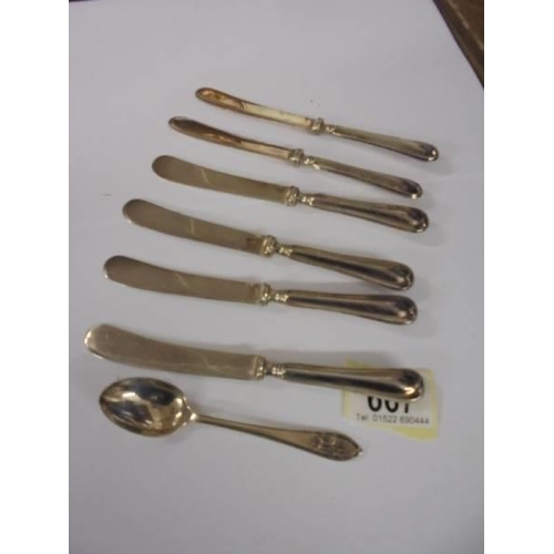 667 - Six silver handled butter knives and a silver spoon.