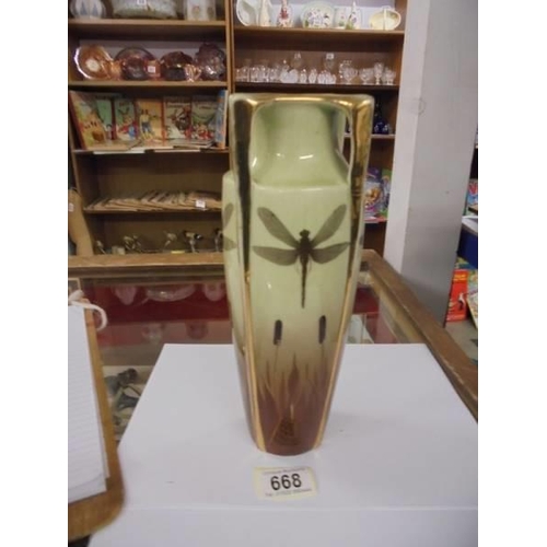 668 - A gilded ceramic vase decorated with dragon flies.