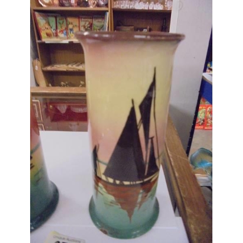 677 - A pair of Doulton style hand painted vases, one a/f.