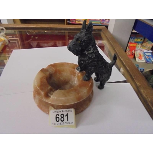 681 - An art deco spelter scottie dog standing on an onyx ashtray.