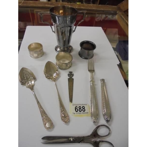 688 - A mixed lot including napkin rings, cutlery etc.,