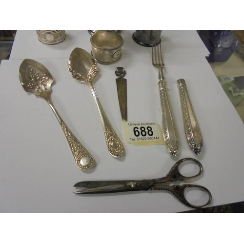 688 - A mixed lot including napkin rings, cutlery etc.,