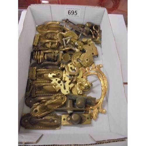 695 - A quantity of brass furniture fittings.