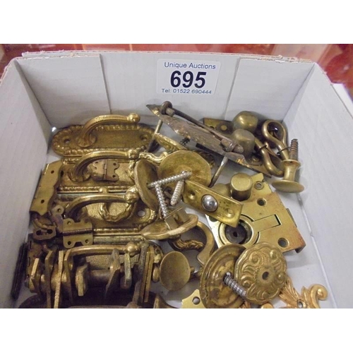 695 - A quantity of brass furniture fittings.