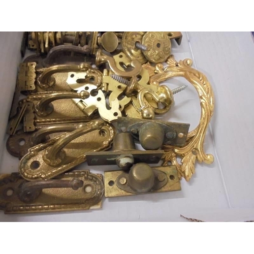 695 - A quantity of brass furniture fittings.