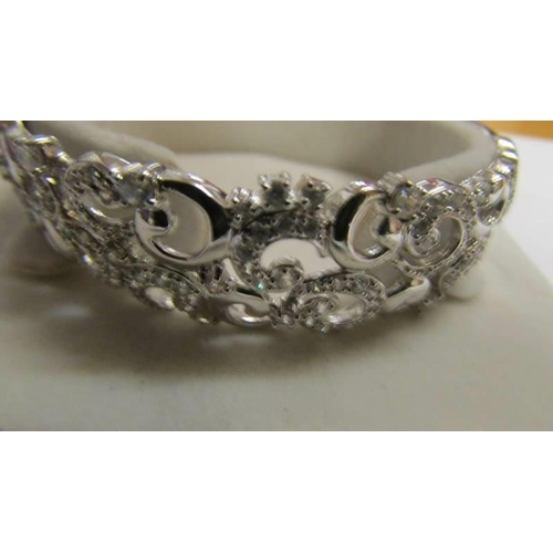 12 - An ornate silver bangle, 22 grams.