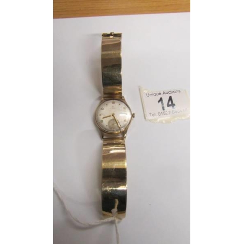 14 - A 9ct gold Omega wrist watch on a 9ct gold bracelet, in working order. 36 grams total weight.