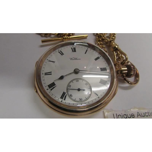 23 - A Waltham pocket watch and chain, gold filled case, 50mm diameter, white dial, in working order. Ser... 