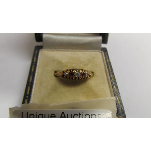 9 - An 18ct gold diamond and ruby ring, size N, 2.7 grams.