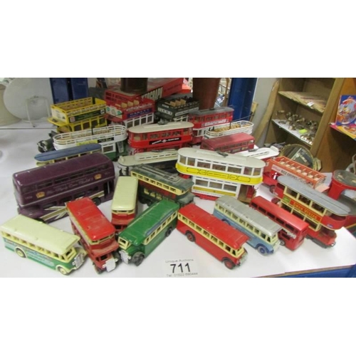 711 - A good lot of die cast trams and buses.