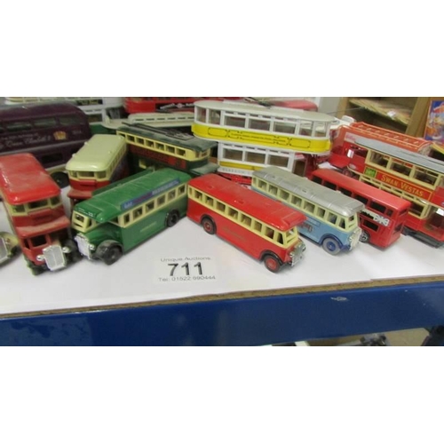 711 - A good lot of die cast trams and buses.