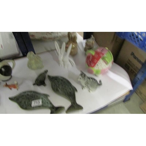 713 - A shelf of miscellaneous items including piggy bank, mostly animal related items etc.,