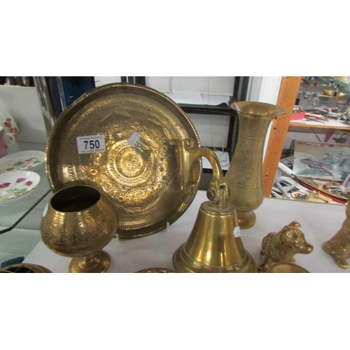 750 - A mixed lot of brass ware including bell, candlesticks etc.,