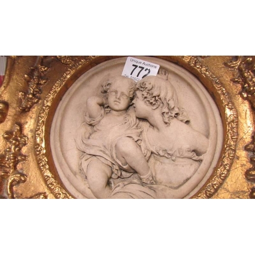 772 - A cherub plaque in a gilded frame.