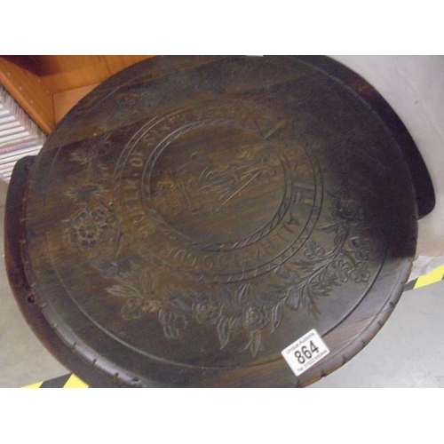 864 - A carved top table. COLLECT ONLY.