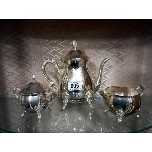 605 - A three piece silver plate tea set.