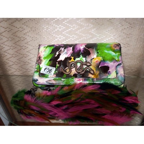 606 - A multi coloured designer handbag decorated with a snake and with feather strap.