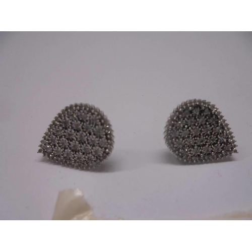 32 - A pair of pear shaped white gold and diamond ear clips.