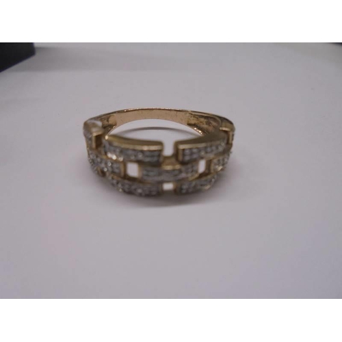 36 - A white/yellow gold Greek key pattern diamond ring, size O, 3.5 grams