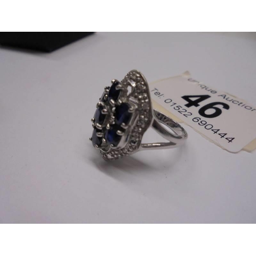 46 - A large white gold sapphire and diamond ring, size M half, 5.6 grams.