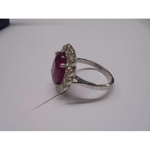 48 - A 6.5 carat oval ruby platinum and diamond ring, size N half, 8 grams.