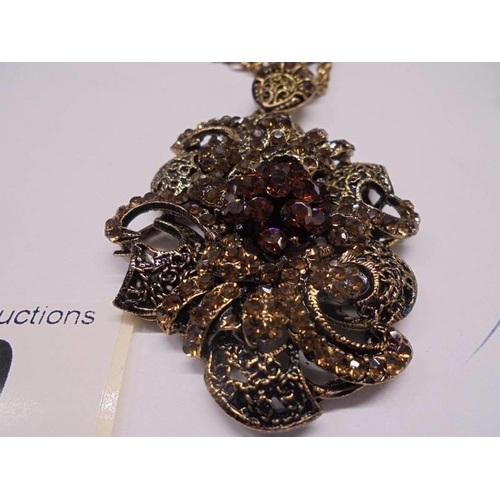 50 - A vintage ornate pendant with matching earrings.