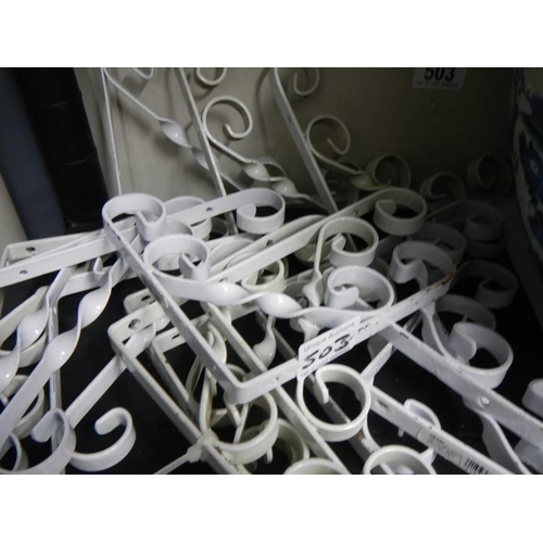 503 - A quantity of new and used scrolly metal shelf brackets.