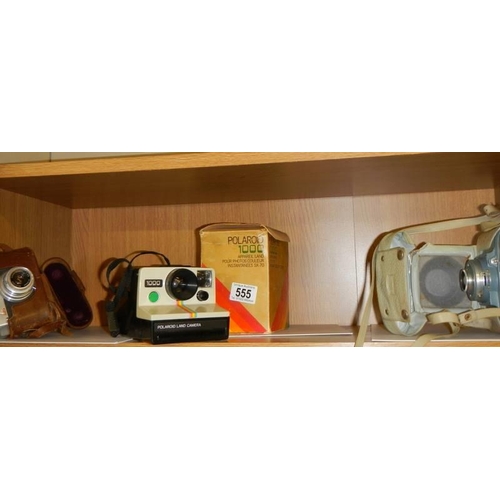 555 - An old Polaroid camera and two other camera's.