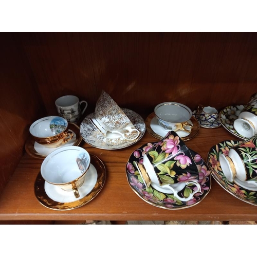 573 - A selection of china cups & saucers including Royal Albert