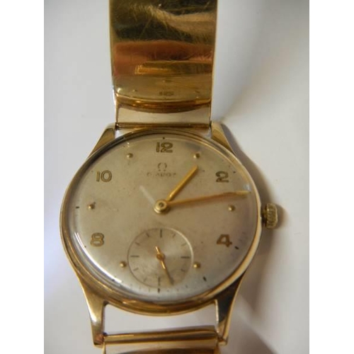 14 - A 9ct gold Omega wrist watch on a 9ct gold bracelet, in working order. 36 grams total weight.