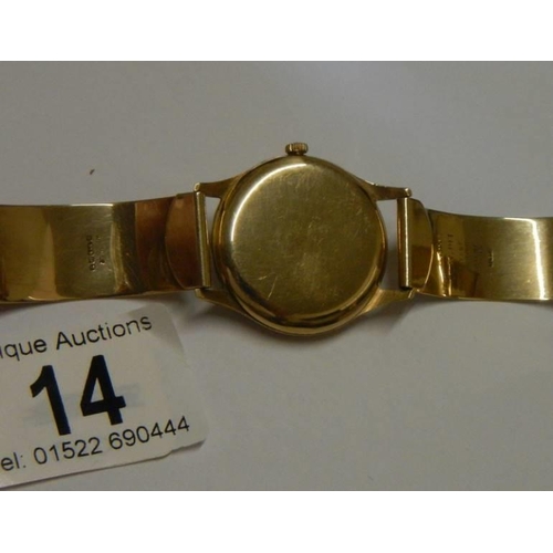 14 - A 9ct gold Omega wrist watch on a 9ct gold bracelet, in working order. 36 grams total weight.