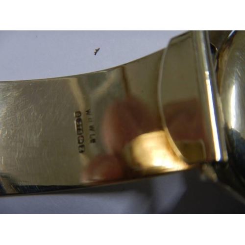 14 - A 9ct gold Omega wrist watch on a 9ct gold bracelet, in working order. 36 grams total weight.