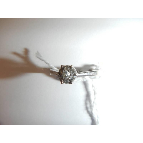 29 - A white gold floral diamond ring, size N half, 1.9 grams.