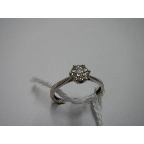 29 - A white gold floral diamond ring, size N half, 1.9 grams.