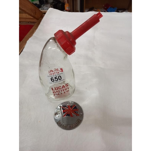 650 - A vintage Lucas glass battery filler bottle and a Great Britain car badge.