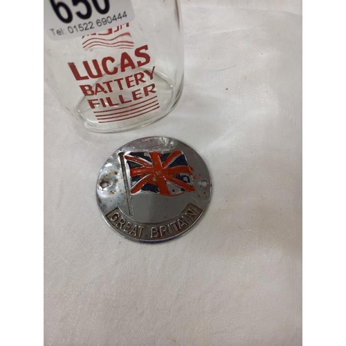 650 - A vintage Lucas glass battery filler bottle and a Great Britain car badge.