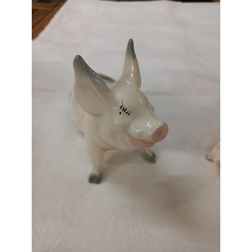 672 - Three Beswick novelty pigs.