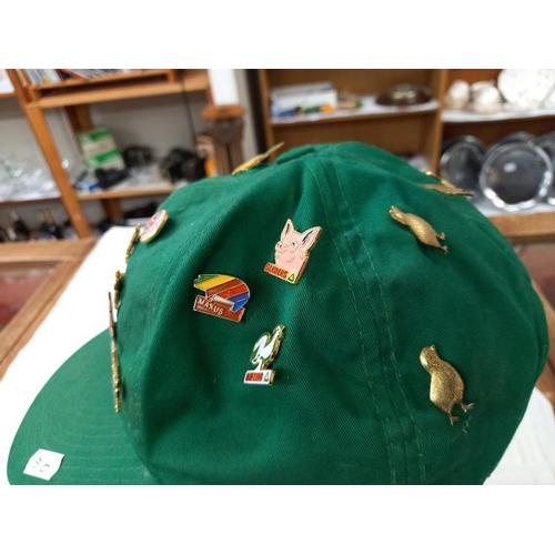 675 - A quantity of badges on a cap.