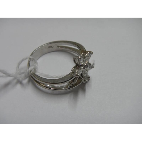 34 - An 18ct white gold floral diamond ring, size O, 5.4 grams