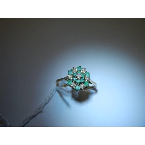 39 - A floral emerald and diamond ring in yellow gold, size Z, 2.4 grams.